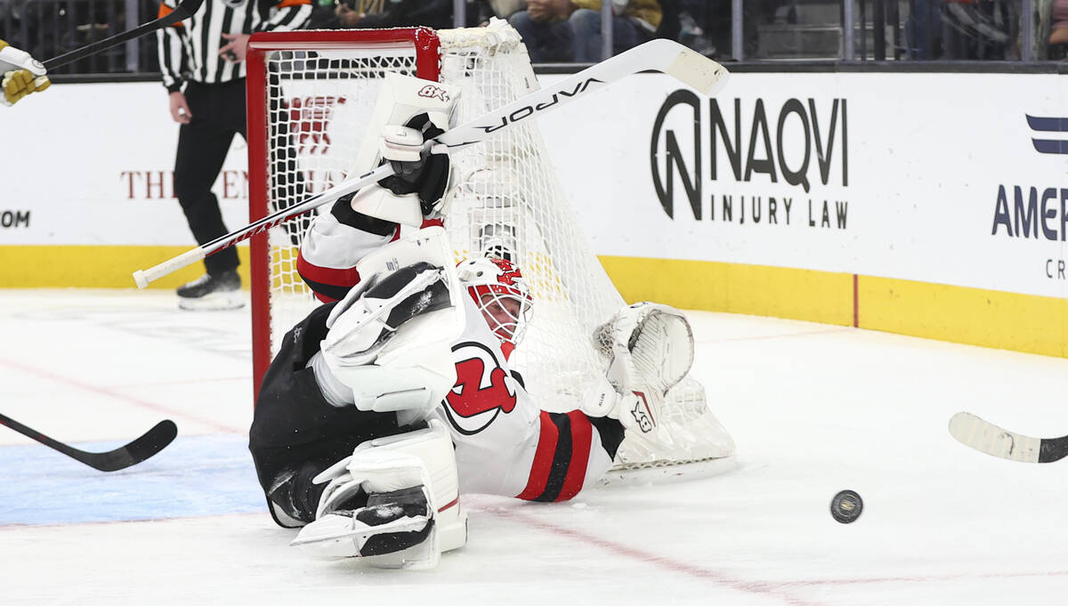 New Jersey Devils goaltender Jake Allen (34) blocks a shot from Golden Knights defenseman Ben H ...