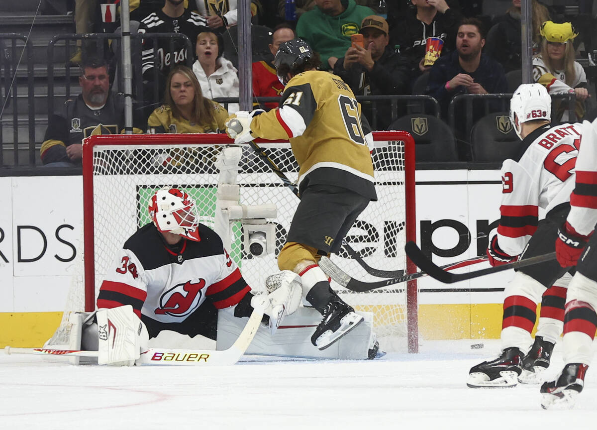 New Jersey Devils goaltender Jake Allen (34) blocks a shot from Golden Knights right wing Mark ...