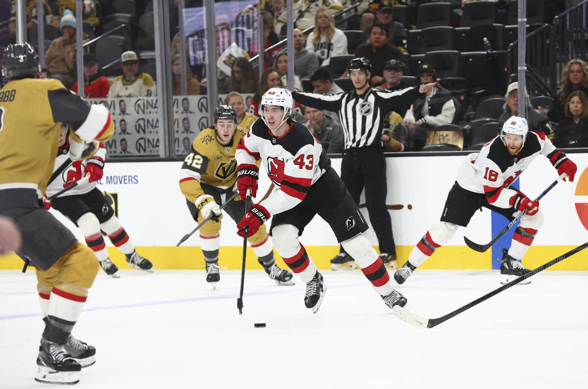 New Jersey Devils defenseman Luke Hughes (43) skates with the puck against the Golden Knights d ...