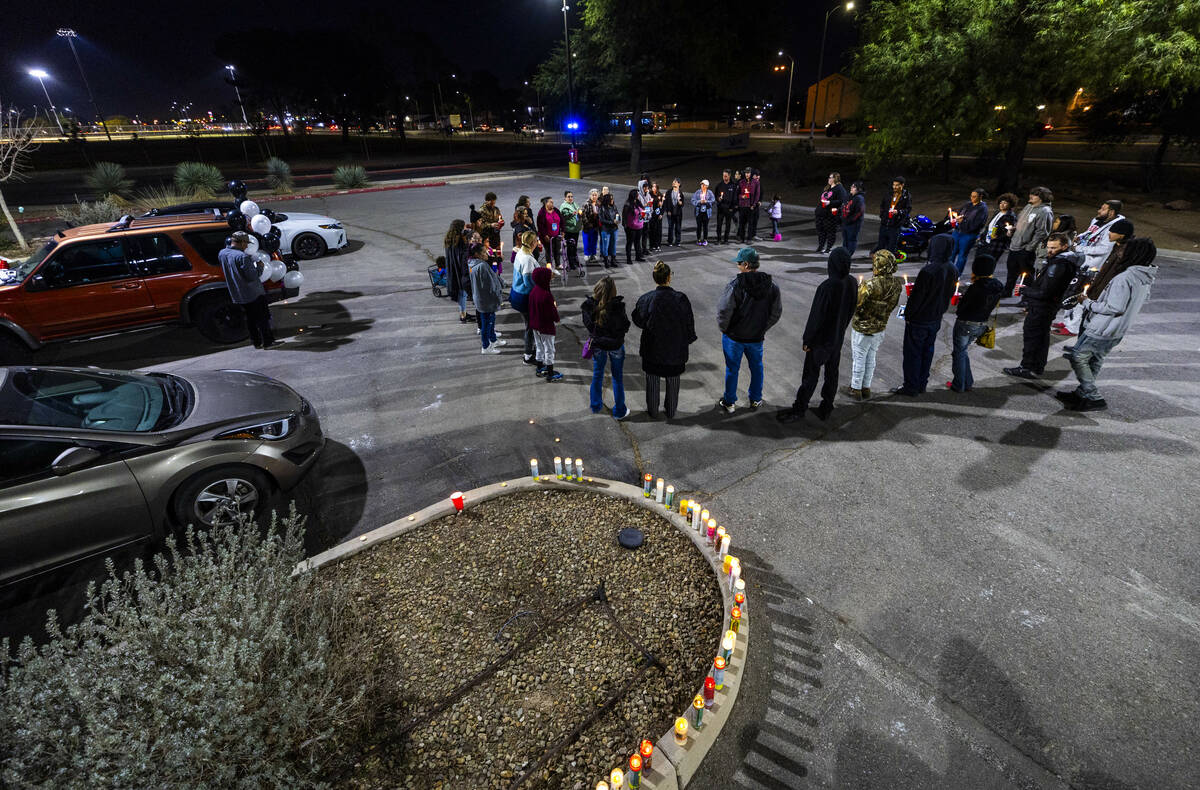 Family and friends gather to recall the life of James Leamy Jr., during a candlelight vigil in ...