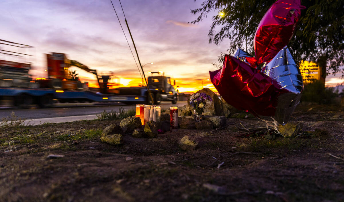 Balloons, a stone marker, flowers and lit candles in remembrance of James Leamy Jr., during a v ...