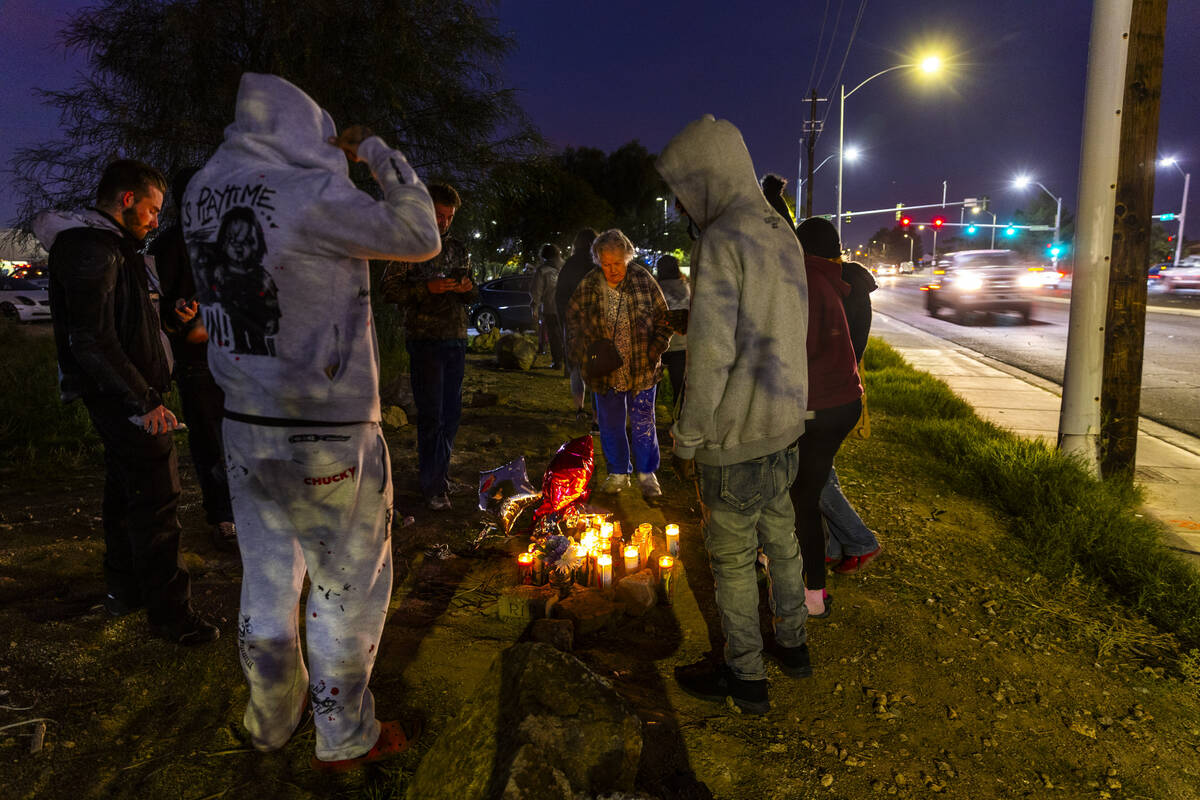 Family and friends light candles in remembrance of James Leamy Jr., during a vigil for him near ...