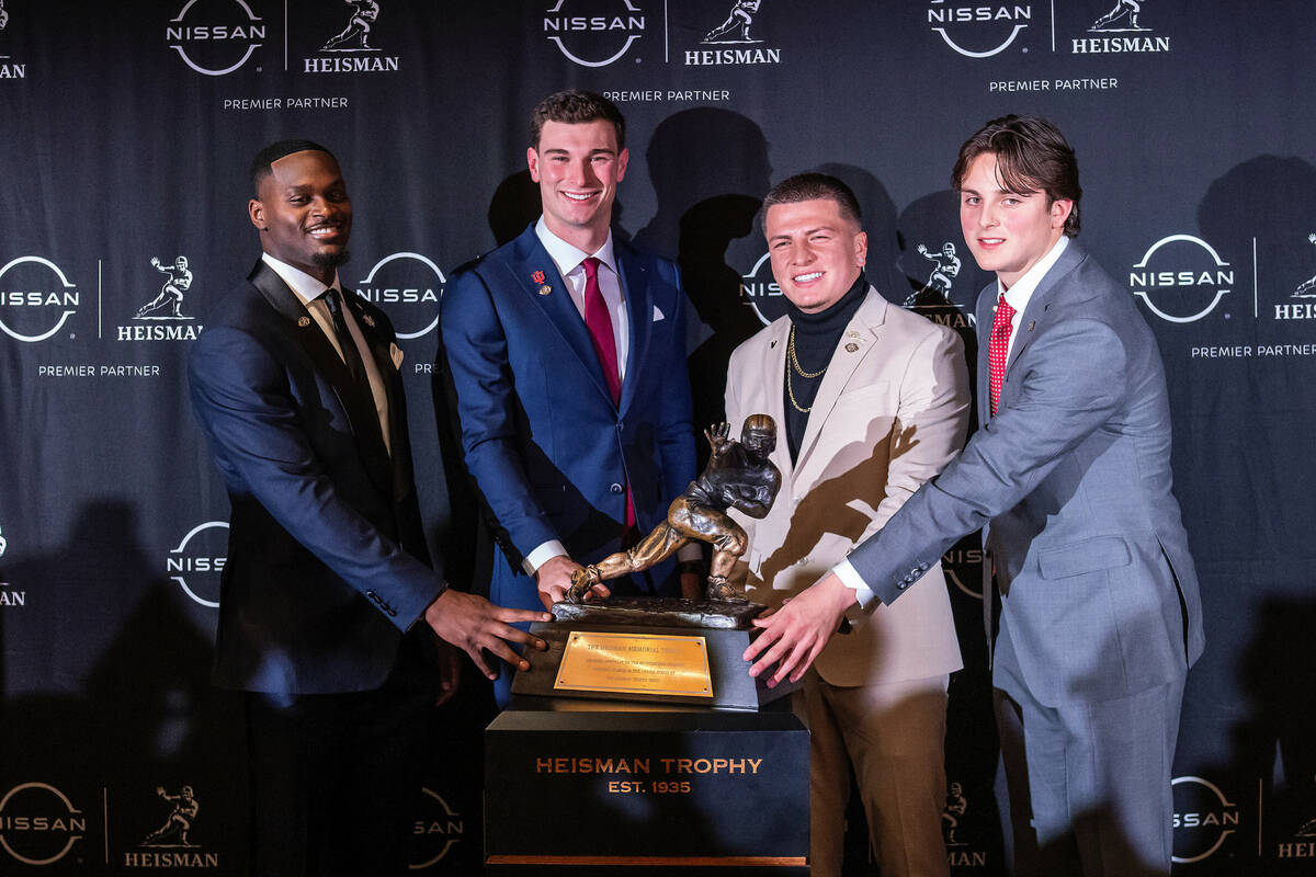 Heisman Trophy finalists, from left to right, Notre Dame running back Jeremiah Love, Indiana qu ...