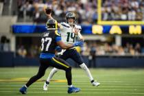 Seattle Seahawks quarterback Sam Darnold (14) throws a pass over Los Angeles Rams safety Quenti ...