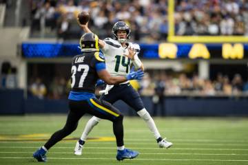 Seattle Seahawks quarterback Sam Darnold (14) throws a pass over Los Angeles Rams safety Quenti ...