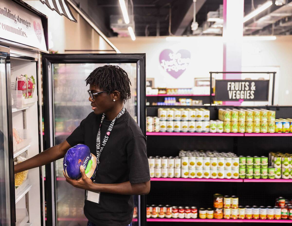 Volunteer Joshua Burnett works in the food pantry at The Just One Project Thursday, Dec. 18, 20 ...