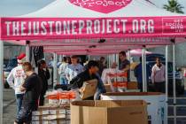 Volunteers bag and hand out food at The Just One Project Thursday, Dec. 18, 2025 in Las Vegas. ...