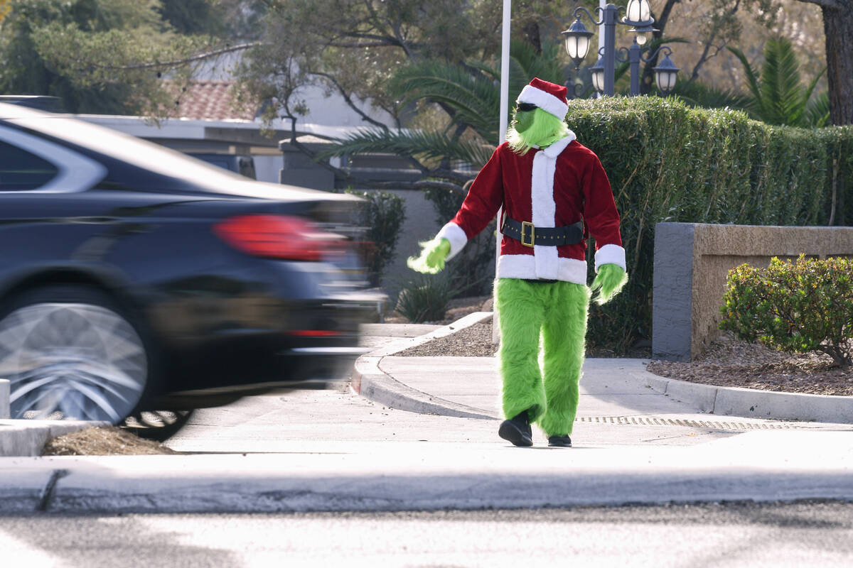 A car fails to yield to Clark County School District police officer Keith Habig in a crosswalk ...