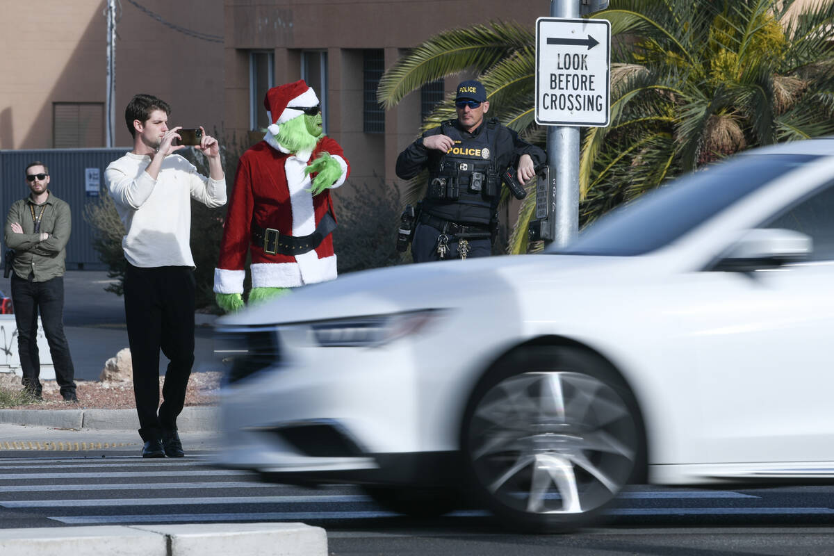 A car fails to yield to Clark County School District police officer Keith Habig in a crosswalk ...