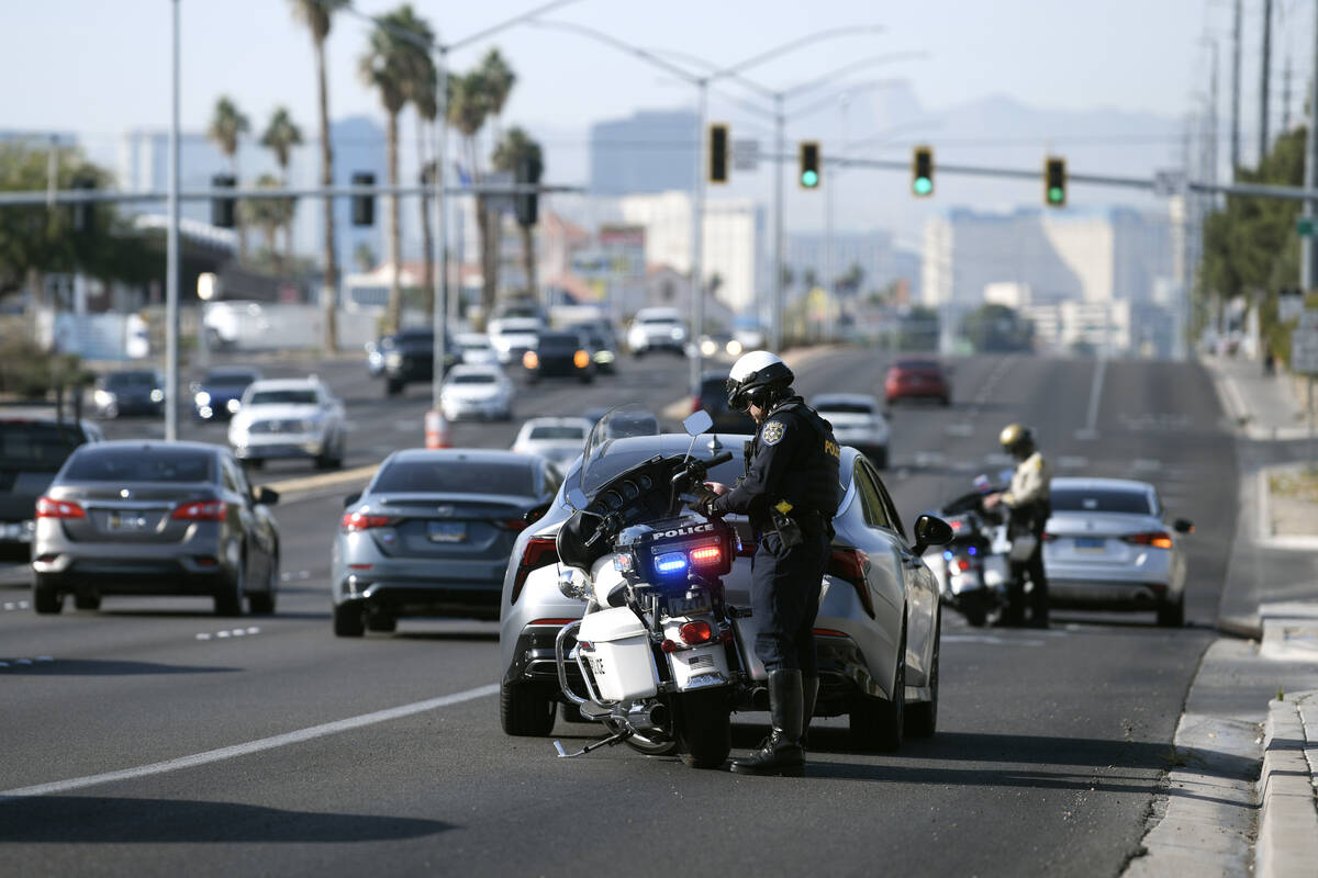 Police officers ticket drivers on Flamingo Road for failure to yield to a pedestrian as multipl ...