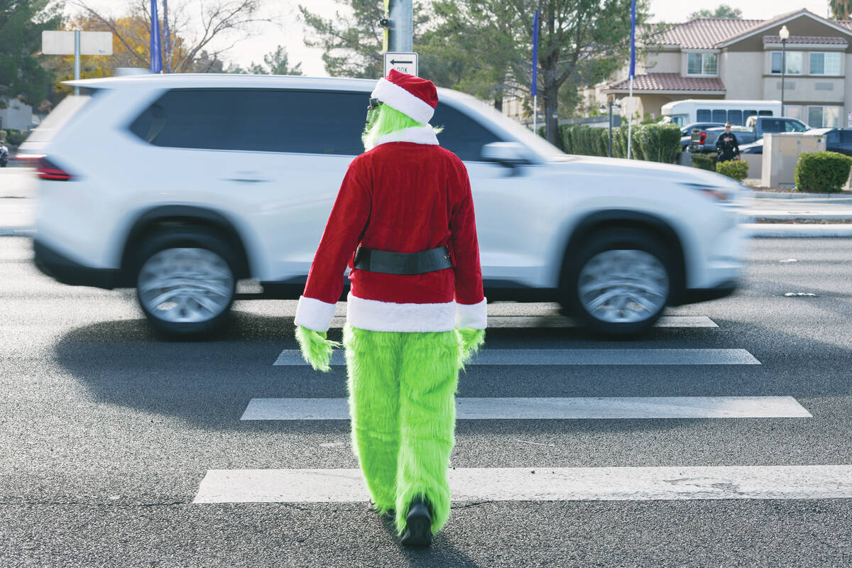 A car fails to yield to Clark County School District police officer Keith Habig in a crosswalk ...
