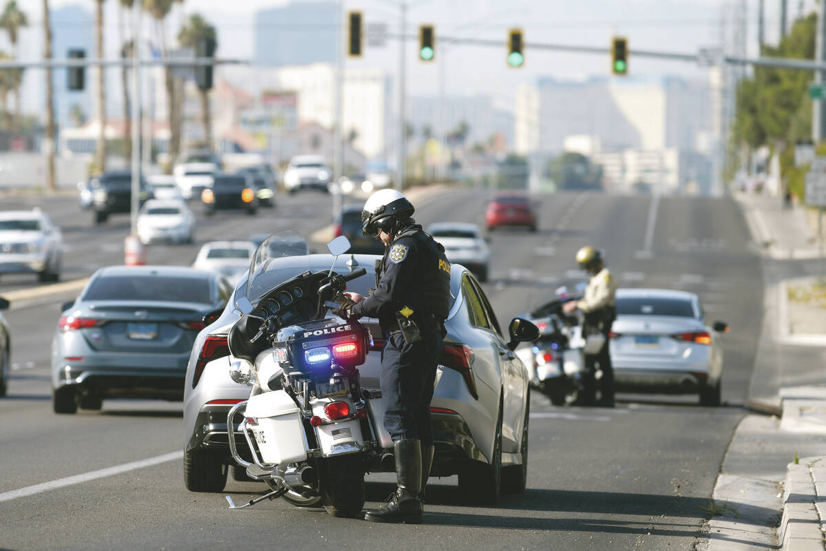 Police officers ticket drivers on Flamingo Road for failure to yield to a pedestrian as multipl ...