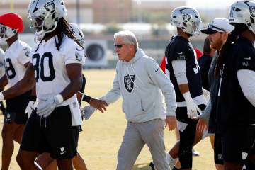 Raiders head coach Pete Carroll greets players as they take the field during the team’s ...