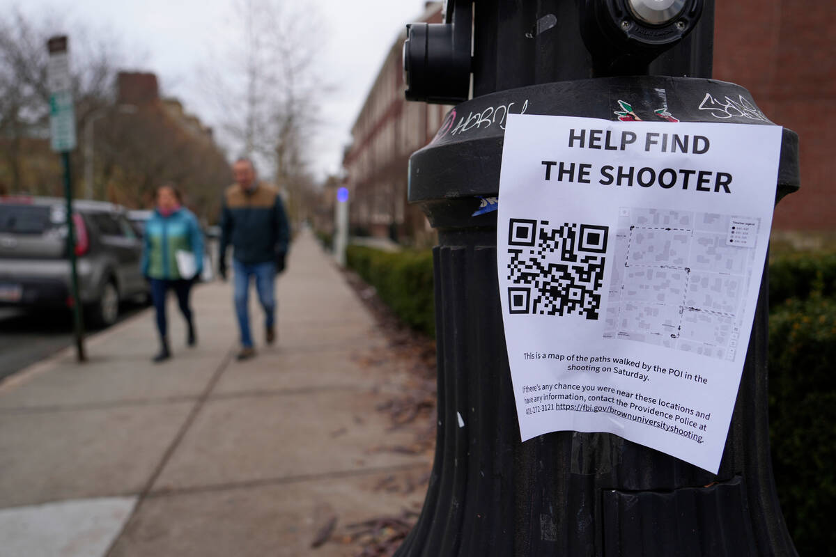 A poster seeking information about the campus shooting suspect is seen on the campus of Brown U ...