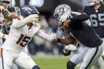 Denver Broncos linebacker Nik Bonitto (15) pursues Raiders quarterback Geno Smith (7) during th ...