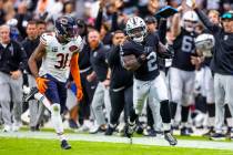Raiders running back Ashton Jeanty (2) sprints down the sidelines pursued by Chicago Bears free ...