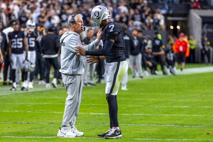 Raiders head coach Pete Carroll consoles quarterback Geno Smith (7) as they need a late score i ...