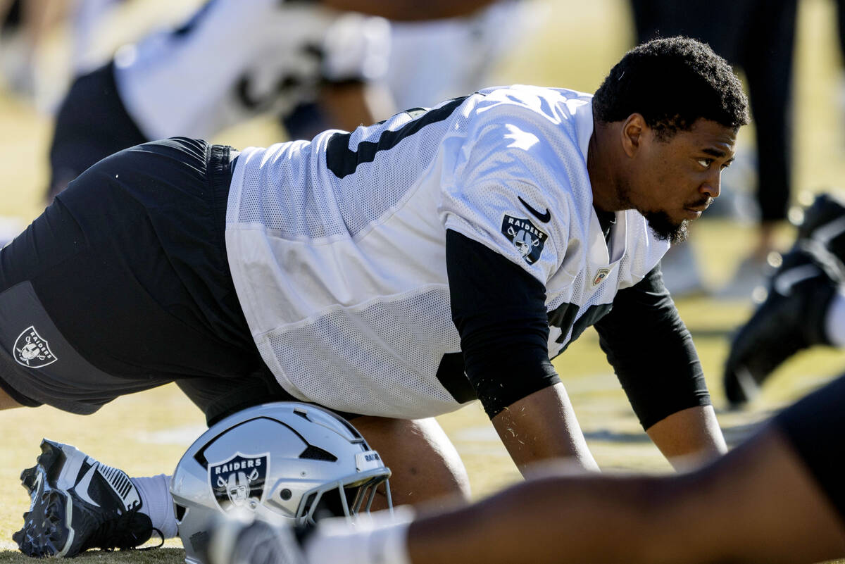 Raiders offensive tackle Charles Grant (60) stretches during the team’s practice at the ...