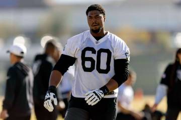 Raiders offensive tackle Charles Grant (60) warms up during the team’s practice at the I ...