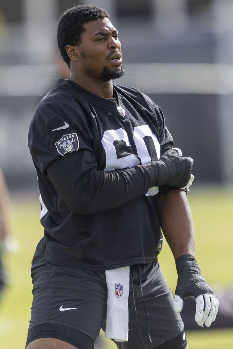 Raiders offensive tackle Charles Grant (60) stretches during the team’s practice at the ...