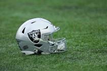 A Las Vegas Raiders helmet sits on the field before an NFL wild-card playoff football game betw ...