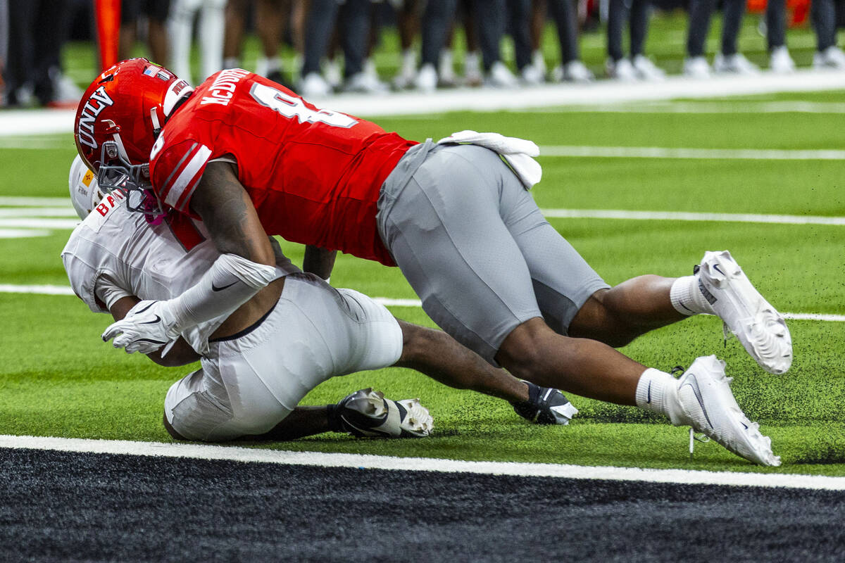 New Mexico Lobos running back Damon Bankston (1) barely avoids a safety as UNLV linebacker Mars ...