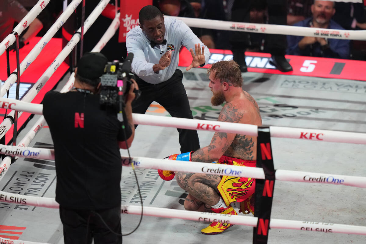 Jake Paul reacts on the canvas after being hit by Anthony Joshua during their heavyweight boxin ...