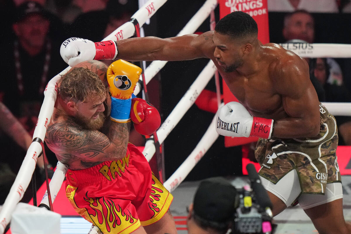 Anthony Joshua, right, punches Jake Paul during their heavyweight boxing match, Friday, Dec. 19 ...