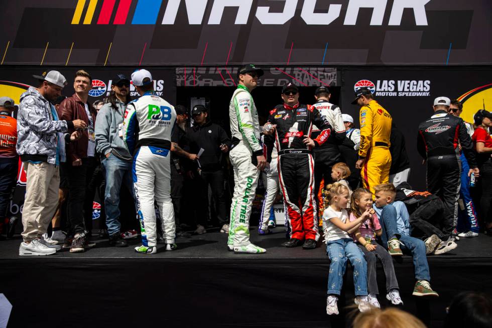 Members of the Backstreet Boys chat with driver John Hunter Nemechek, left, as drivers wait dur ...