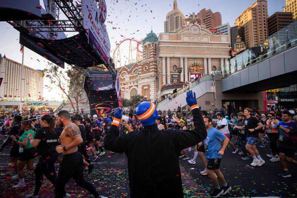 Members of the Blue Man Group interact with race participants as they take off from the start l ...