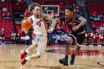 UNLV guard Dravyn Gibbs-Lawhorn (0) dribbles the ball as Fresno State guard Zaon Collins (10) g ...