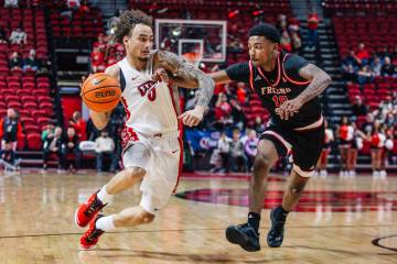 UNLV guard Dravyn Gibbs-Lawhorn (0) dribbles the ball as Fresno State guard Zaon Collins (10) g ...