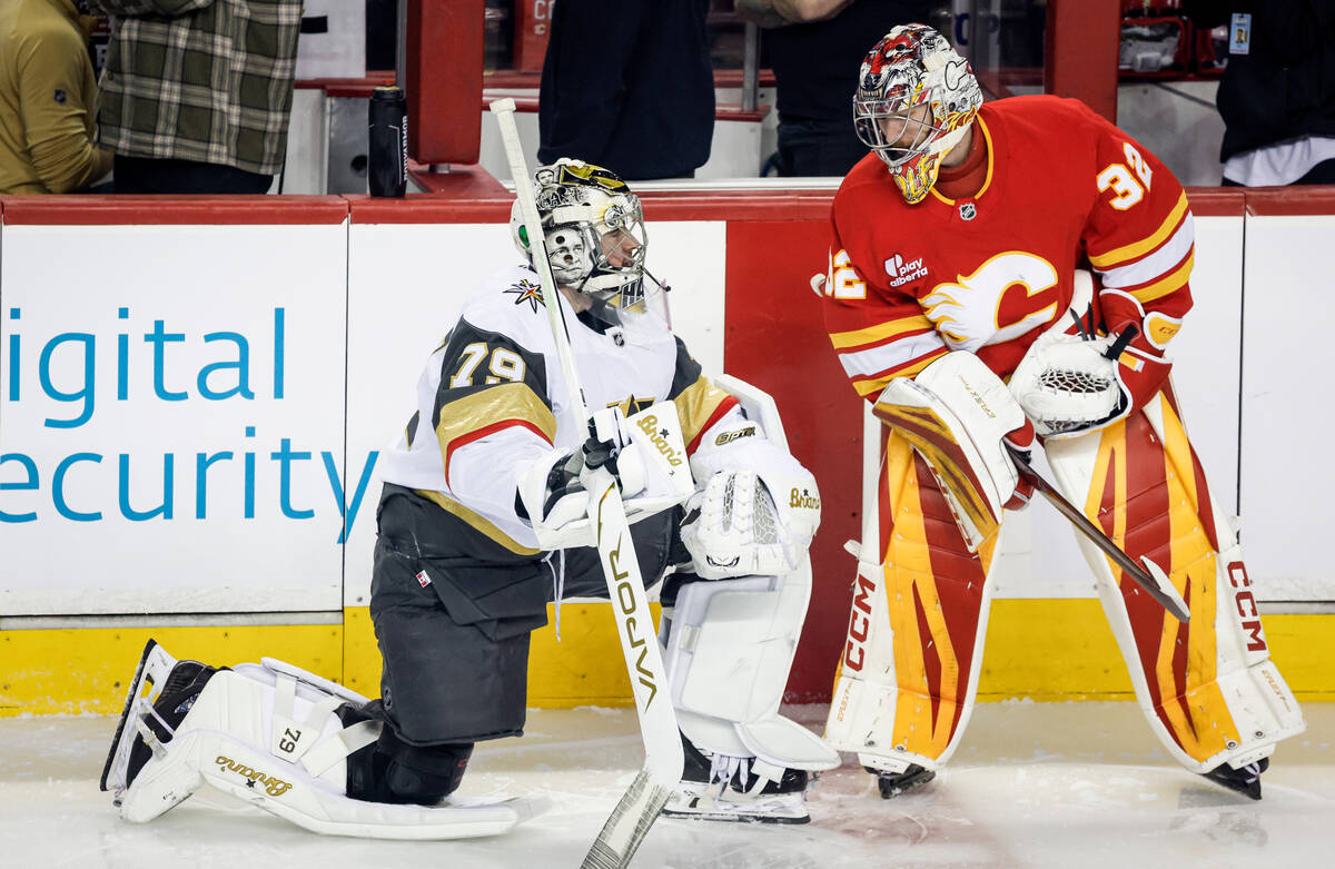 Vegas Golden Knights goalie Carter Hart, left, chats with Calgary Flames goalie Dustin Wolf whi ...