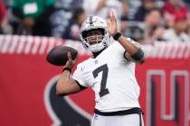 Las Vegas Raiders quarterback Geno Smith (7) warms up before an NFL football game against the H ...