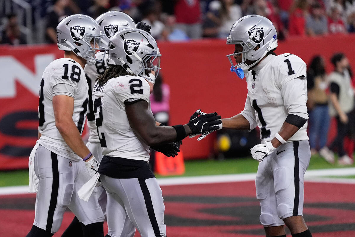 Las Vegas Raiders running back Ashton Jeanty (2) is congratulated by wide receiver Tre Tucker ( ...