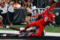 Hawaii defensive back Devyn King (24) tackles UNLV wide receiver Jaden Bradley (6), who made a ...