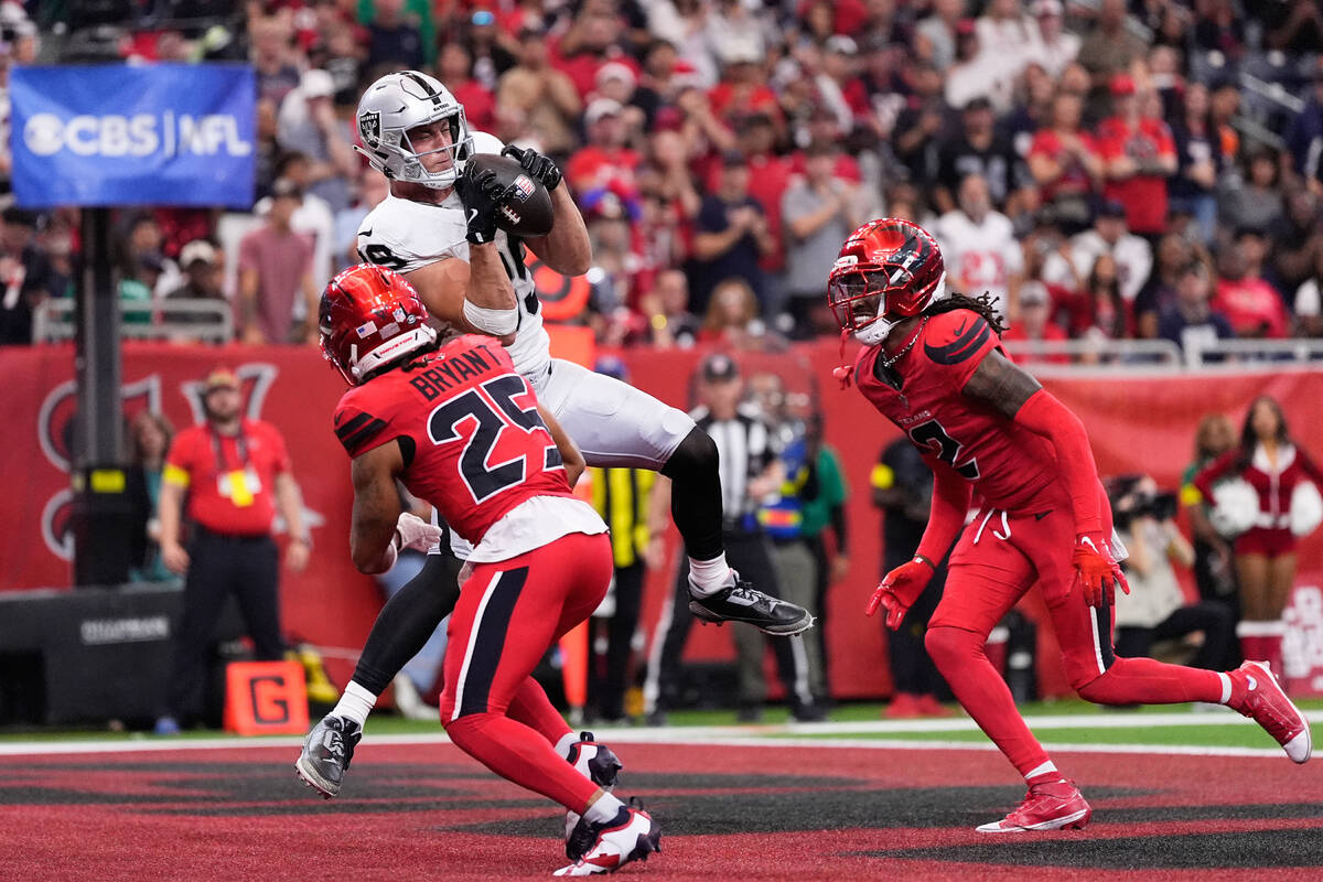 Las Vegas Raiders tight end Brock Bowers, top, catches a touchdown pass against Houston Texans ...
