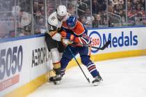 Vegas Golden Knights' Mark Stone (61) and Edmonton Oilers' Vasily Podkolzin (92) batt ...