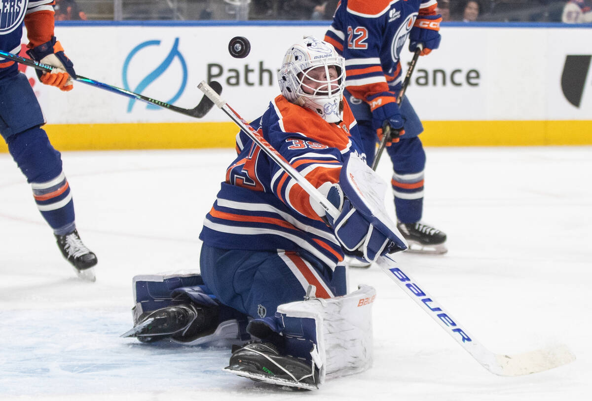 Edmonton Oilers' goalie Connor Ingram, center, makes a save against the Vegas Golden Knigh ...