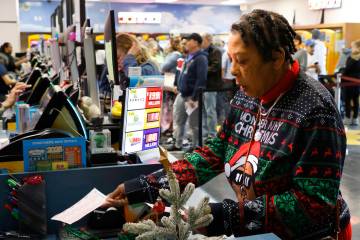 Andrea Jonson of Las Vegas buys her Powerball tickets at the Primm Valley Lotto Store on Monday ...