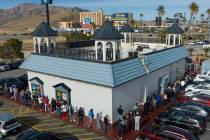 People line up to buy Powerball tickets outside of the Primm Valley Lotto Store on Monday, Dec. ...