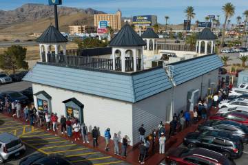 People line up to buy Powerball tickets outside of the Primm Valley Lotto Store on Monday, Dec. ...