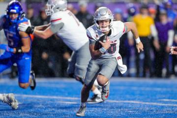 UNLV quarterback Anthony Colandrea runs out of the pocket on a 5-yard touchdown run against Boi ...