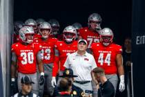 UNLV head coach Dan Mullen walks out of the tunnel with his team while prepared for the first h ...