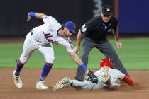 New York Mets second baseman Jeff McNeil, left, tags out Philadelphia Phillies' Bryce Harp ...