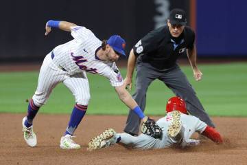 New York Mets second baseman Jeff McNeil, left, tags out Philadelphia Phillies' Bryce Harp ...