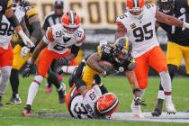 Pittsburgh Steelers running back Jaylen Warren (30) leaps over Cleveland Browns safety Ronnie H ...