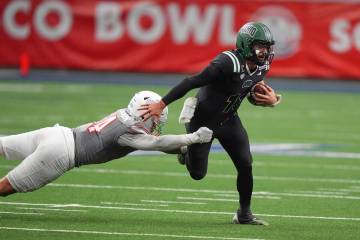 Ohio quarterback Parker Navarro (13) eludes UNLV linebacker Isaiah Patterson (54) during the se ...