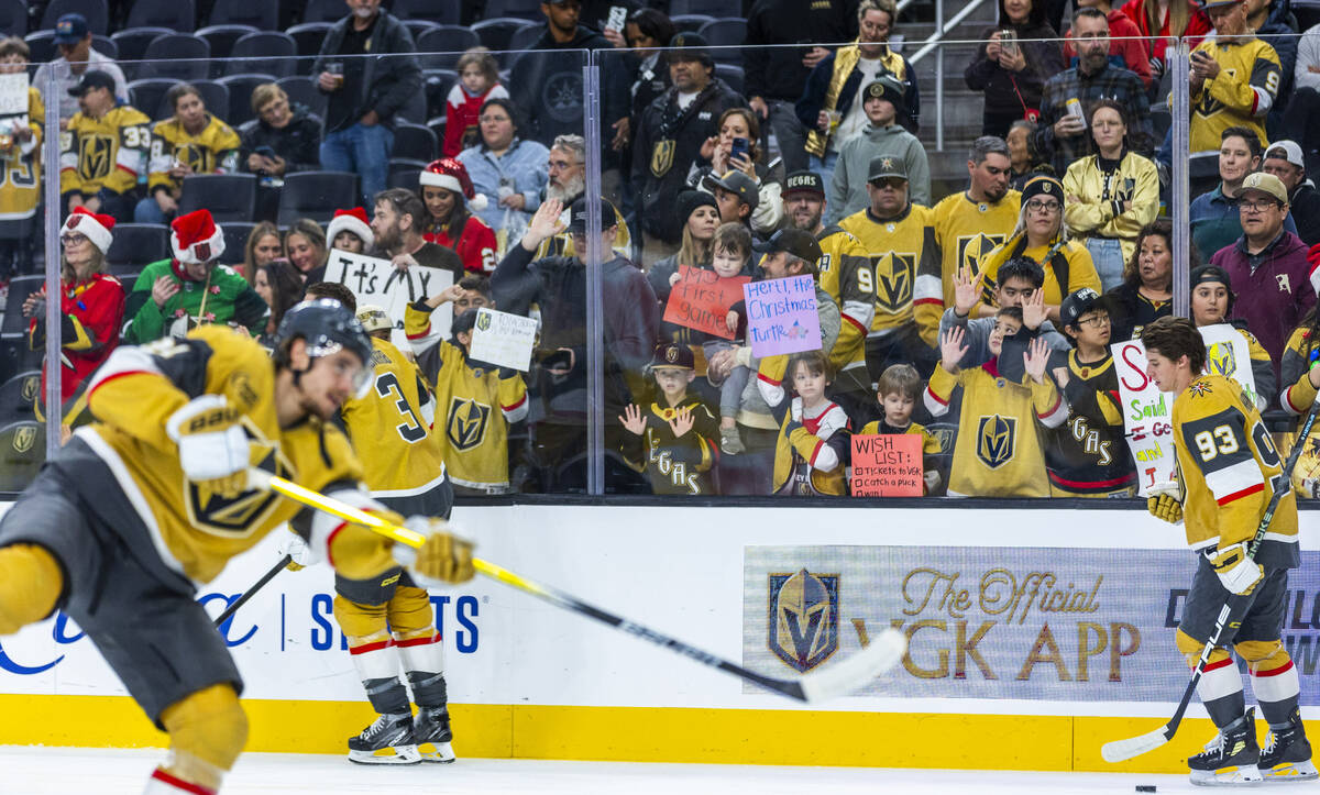 Golden Knights fans present signs and watch the team in warm ups before facing the San Jose Sha ...