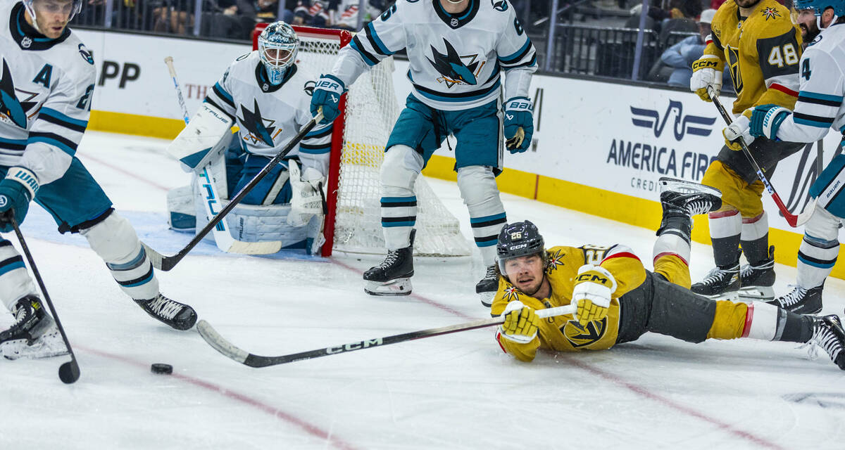 Golden Knights right wing Alexander Holtz (26) advances the puck from the ice as San Jose Shark ...